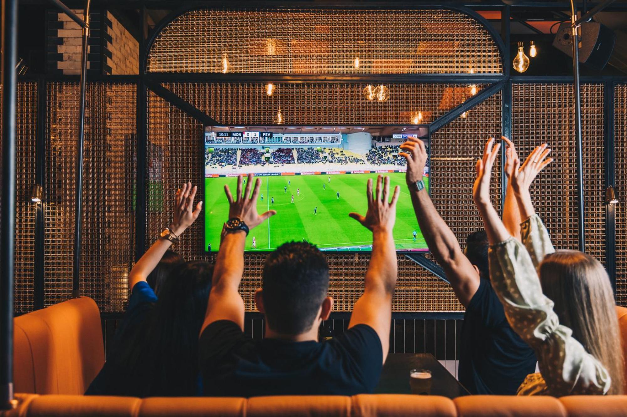 Five Jumeirah Village Dubai Exterior photo Watching a game on television